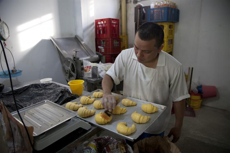 A man baking croissants