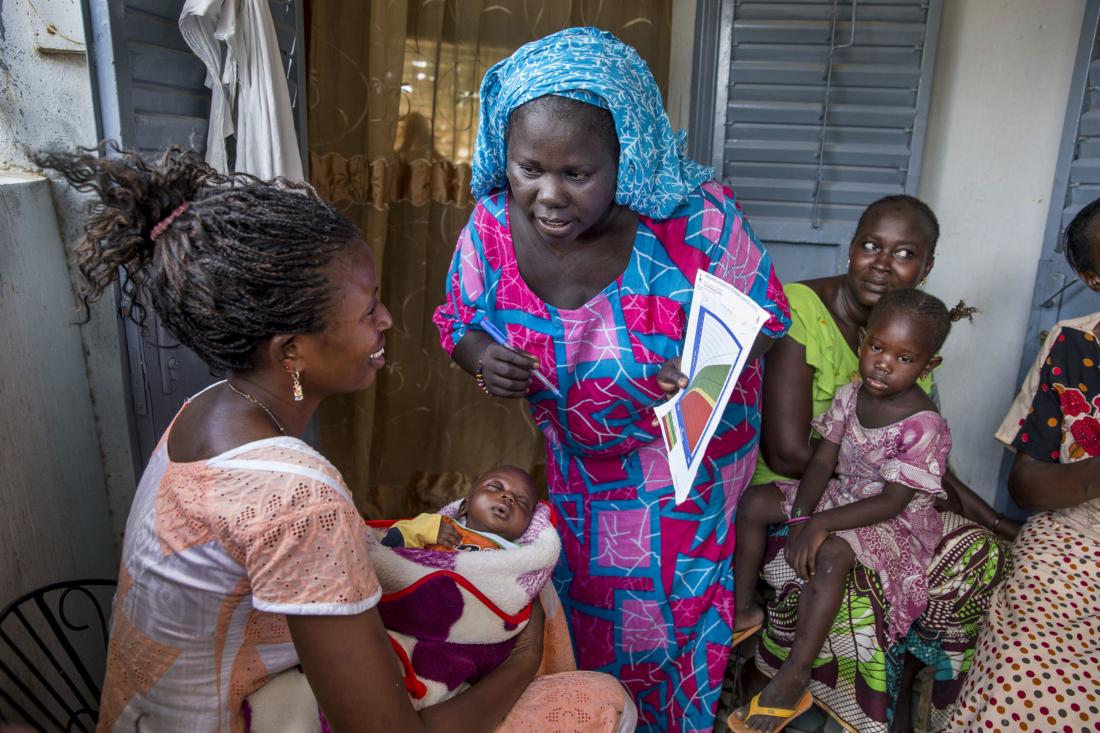 A community health worker providing women in her community counseling and post natal care at her home.