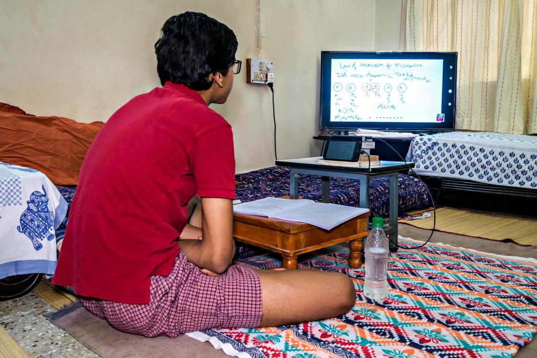 boy sitting in front of his computer for online learning