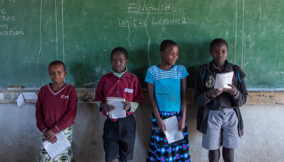 A group of students in front of a chalkboard