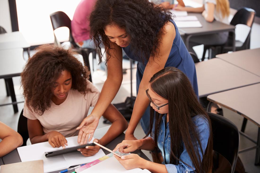 Teacher working with middle school students