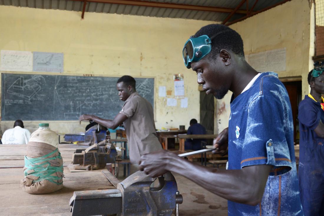 Two men working on employment growth in training program in Tanzania