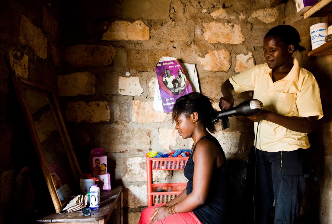 Mother blow drys daughter's hair