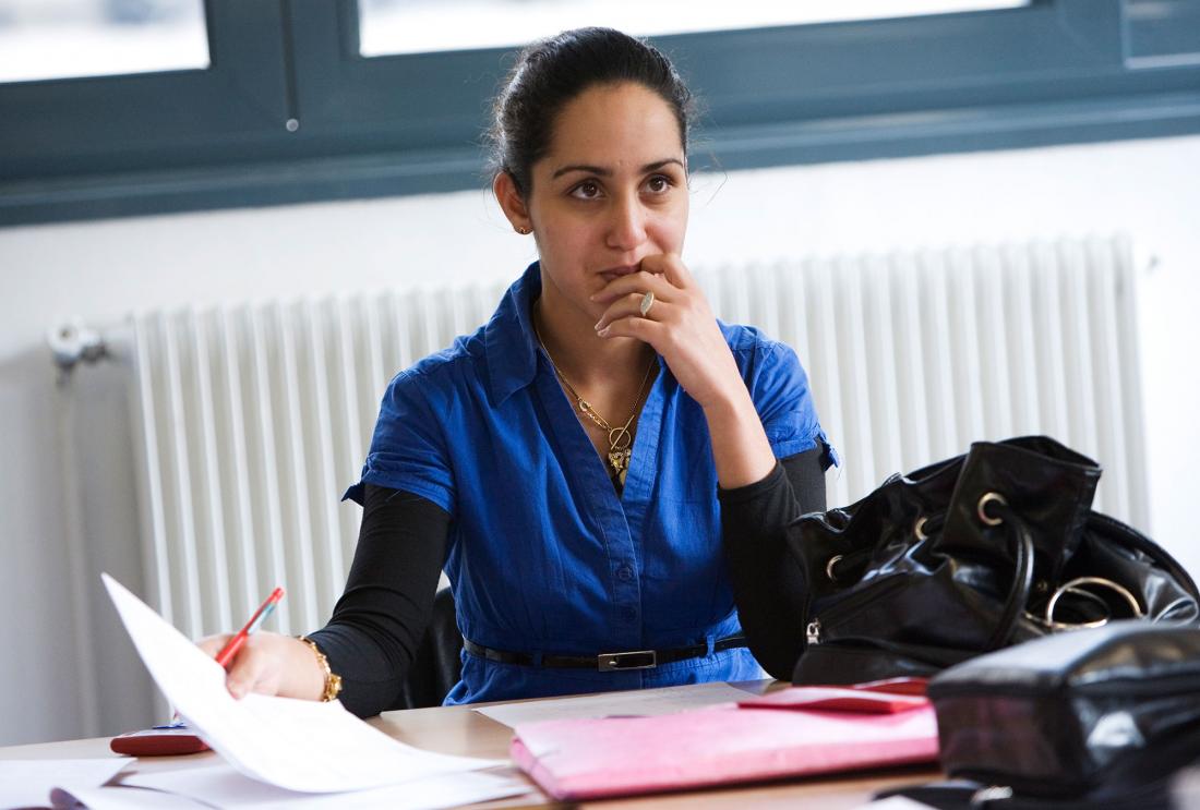 Woman reads papers at her desk