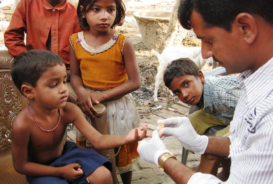 Child having his finger pricked in Bihar, India