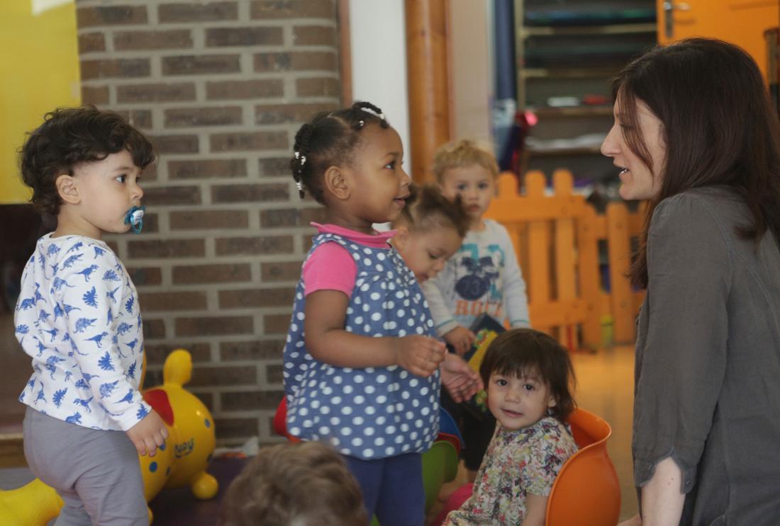 A teacher engaging with children as part of Parler Bambin