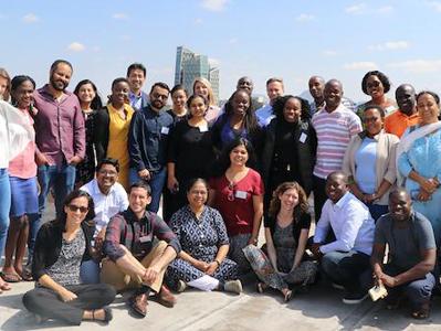 A group of J-PAL and TaRL staff pose together outside