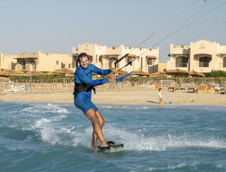 A photo of a man kitesurfing.