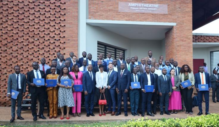 The first cohort of Ivorian civil servants to graduate from the joint program pose holding their certificates with J-PAL Europe staff and partners.