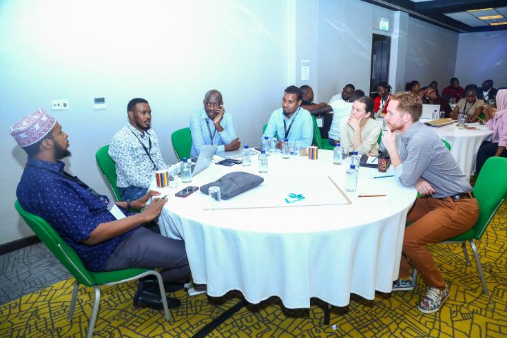 A group of people talk at a table. 