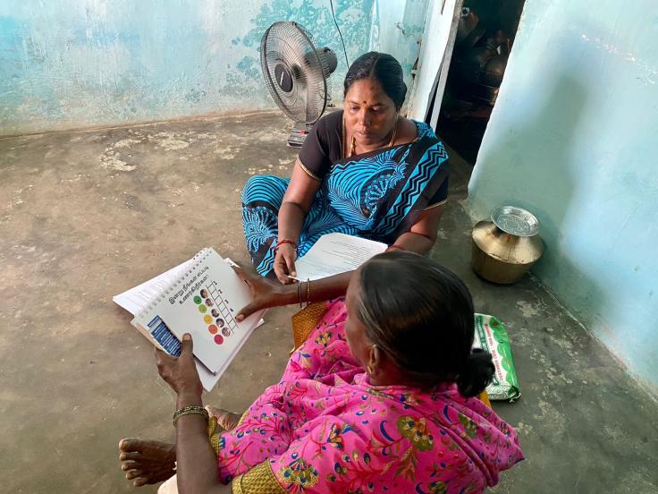 An elderly individual reviewing the mood ladder card as part of the CBT intervention pilot in Tiruchirappalli, Tamil Nadu.