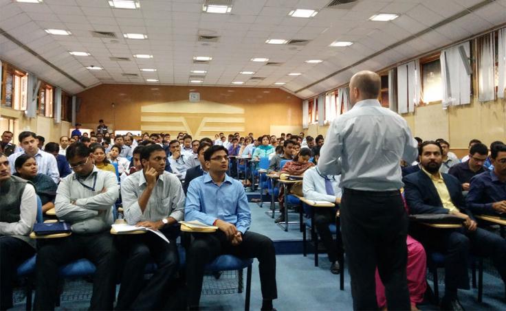 Man lectures in front of a class