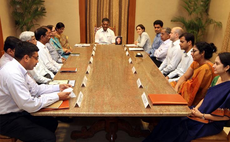 Government officials and J-PAL leadership sit at large table