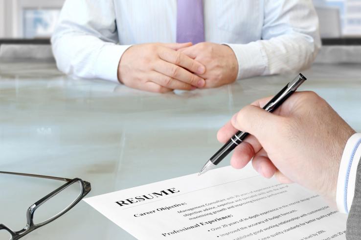 Man looks over resume during a job interview