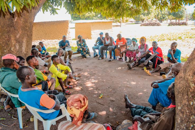 A group of community members arranged in a circle in a social engagement