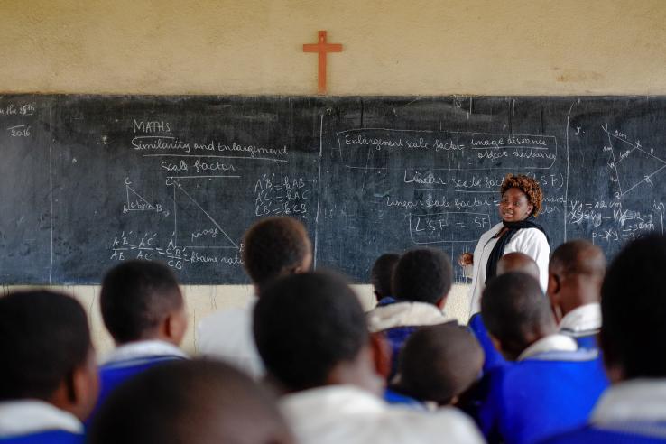 Teacher teaching students in a classroom in Rwanda