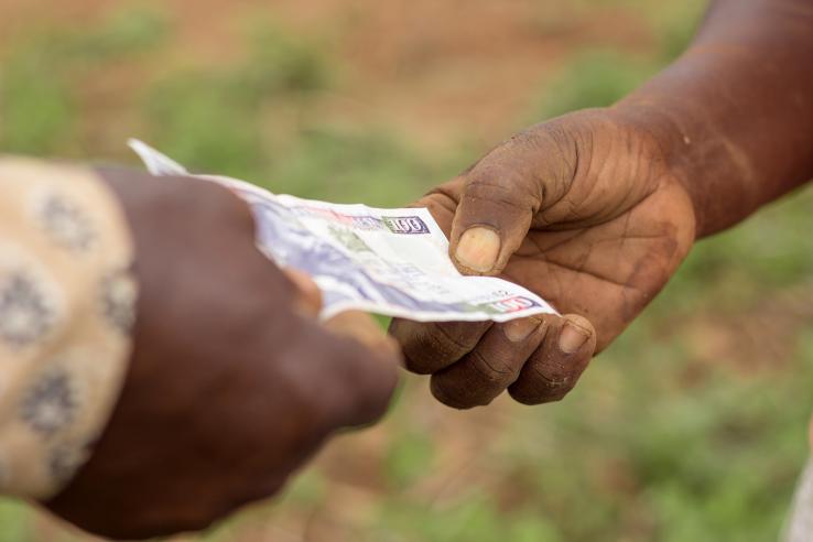 Two people exchanging money in Uganda