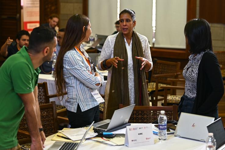 Implementing partners discussing around a table 