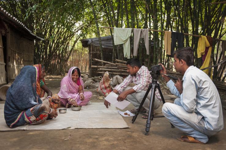 Digital Green staff filming women in how to videos on agricultural practices.