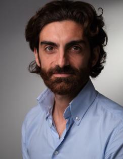 headshot of Paolo Falco wearing a blue shirt