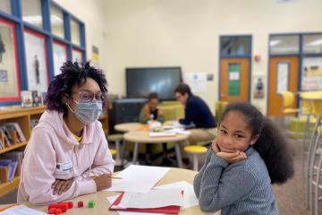 A student and tutor in a classroom