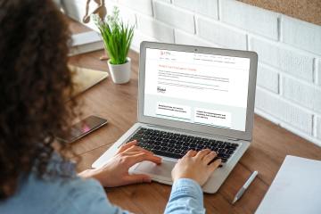 Person looking at computer screen with "Health Care Evaluation Toolkit" landing page