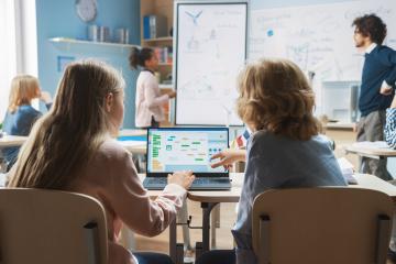 Two students look at a computer screen