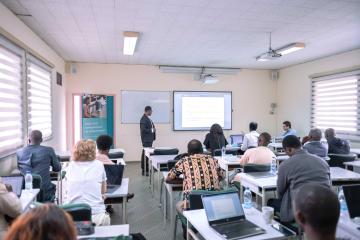 A classroom of students listens to a lecture.