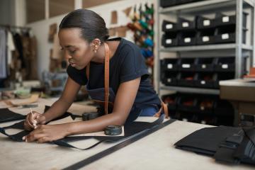 A woman working in a leather textile shop.