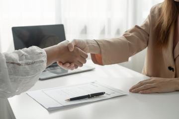 Two women shaking hands